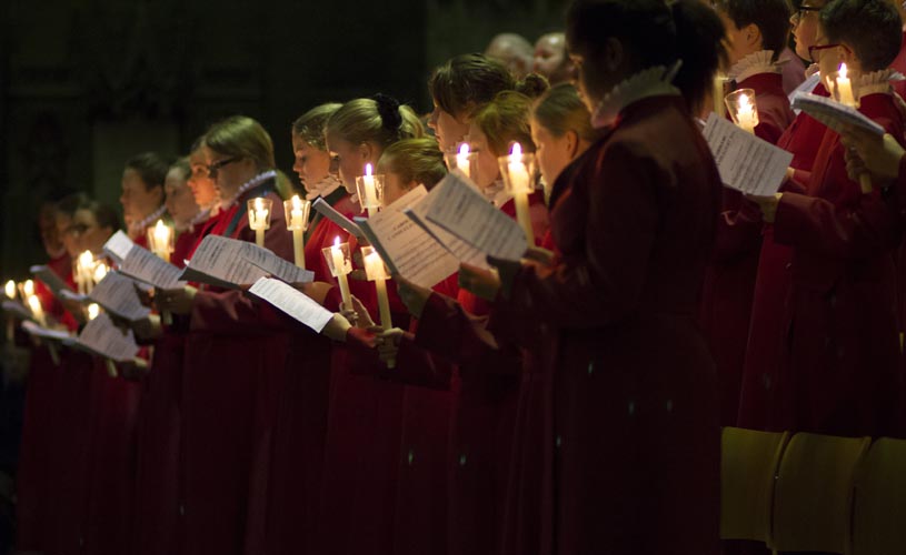 Choir singing by candlelight at Bristol Cathedral